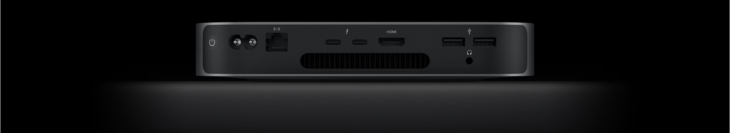 Mac mini’nin iki adet Thunderbolt 4 bağlantı noktasını, HDMI bağlantı noktasını, iki adet USB-A bağlantı noktasını, kulaklık jakını, Gigabit Ethernet bağlantı noktasını, güç bağlantı noktasını ve güç düğmesini gösteren arkadan görünümü.